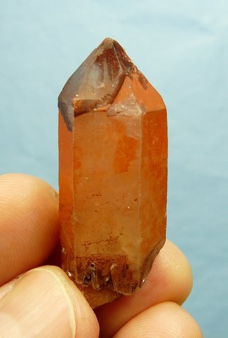 Quartz crystal with dark orangy-brown 'cap'
