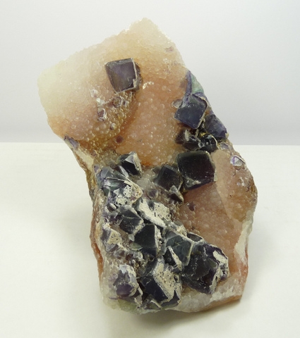 A fairly big (trimmed) specimen of fluorite crystals on chalcedony