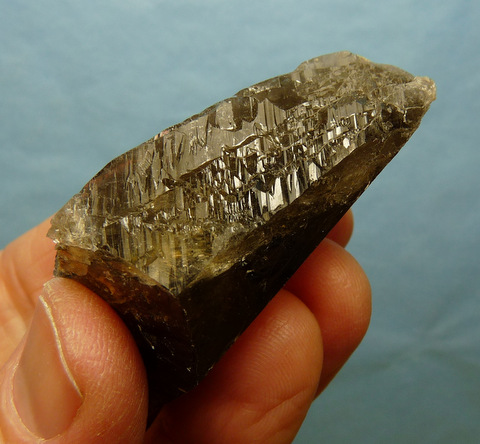 Multi-faceted smoky quartz crystal with peculiar growth patterns