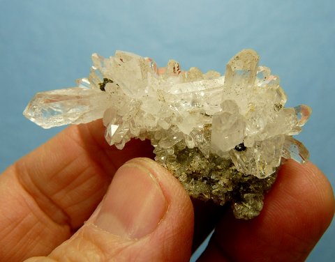 Group of clear quartz crystals on thin matrix