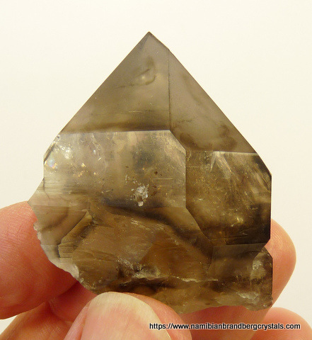 Smoky quartz crystal with darker patches and gas