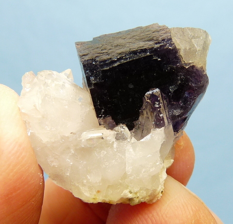 Dark purple fluorite crystal and calcite crystal on quartz matrix