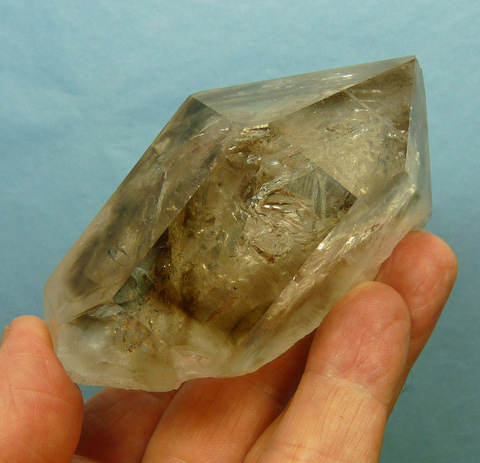 Quartz crystal with light smoky patches and moving