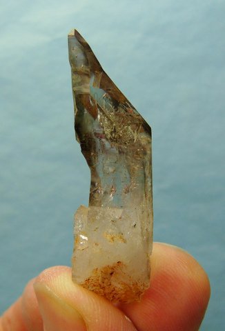 Strangely shaped quartz crystal with window, smoky colour and tinge of amethyst
