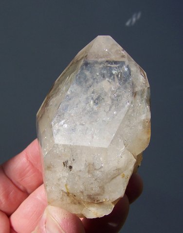 Gemmy, stubby crystal with many gas inclusions and touch of smoky