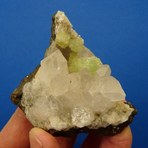 Lovely quartz, prehnite and calcite crystals on basalt matrix.
