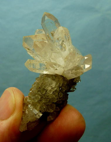 Gemmy cluster of quartz crystals on matrix covered with small quartz and calcite crystals