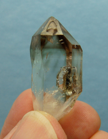 Quartz crystal with smoky termination and unusual gas inclusions