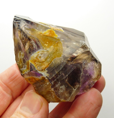Amethyst / smoky quartz crystal with iron oxide inclusions