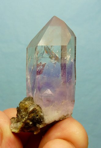 Quartz crystal with light amethyst colour, on matrix