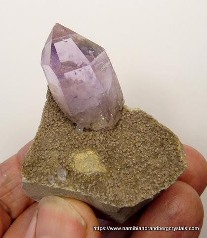 Light amethyst quartz crystal on matrix