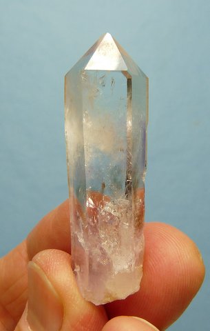 Quartz crystal with light patches of amethyst and smoky