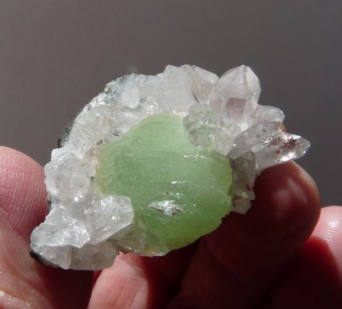 Prehnite ball and quartz crystals on basalt rock