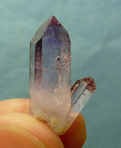 Amethyst quartz crystal group with hematite inclusions