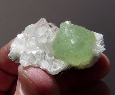 Lovely prehnite ball on calcite crystals, on matrix