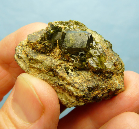 Group of demantoid garnets on garnet and feldspar matrix
