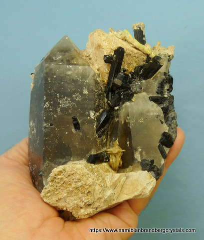 Smoky quartz crystals with schorl, mica, feldspar, and hyalite opal