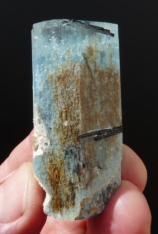 Big aquamarine crystal with gemmy termination and a few small schorl crystals