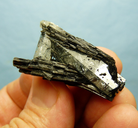 Group of pale blue aquamarine crystals with schorl