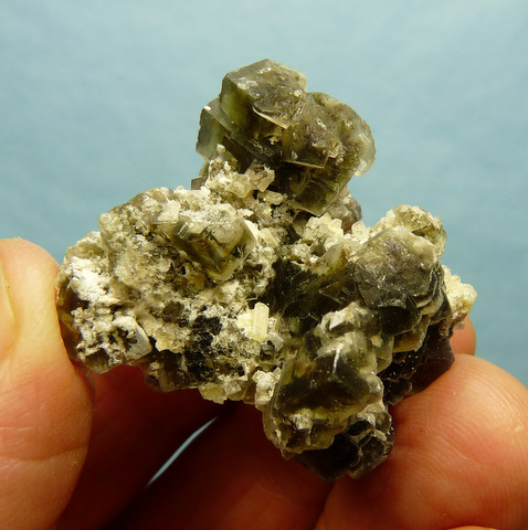 Cluster of greenish fluorite crystals with feldspar