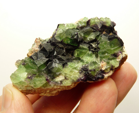 Green and purple fluorite crystals on feldspar matrix
