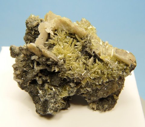 Small, sparkling mimetite crystals and (?)calcite blades on matrix