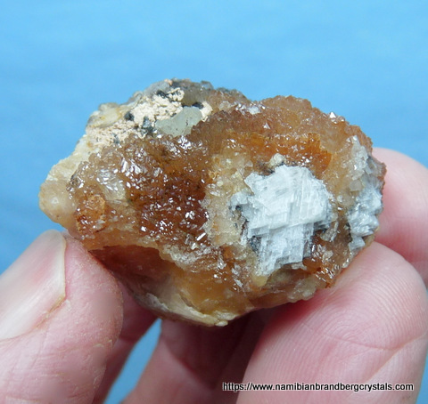 BDrusy aggregates of camel coloured olmiite crystals on small matrix
