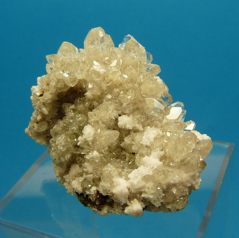 Oyelite crystals on gemmy, sparkling calcite crystals