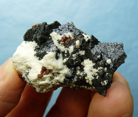 Hausmanite and andradite garnet crystals with calcite