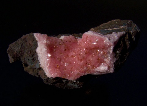 Druse of rhodochrosite crystals on rhodochrosite, on matrix