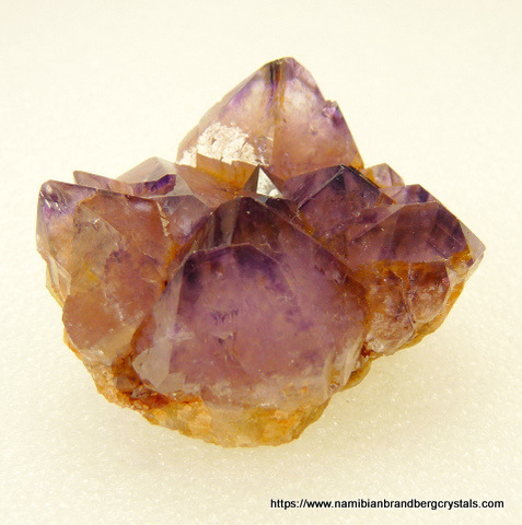 Group of quartz crystals with lovely amethyst colouring, on matrix
