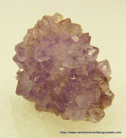 Very small, light amethyst quartz crystals on matrix