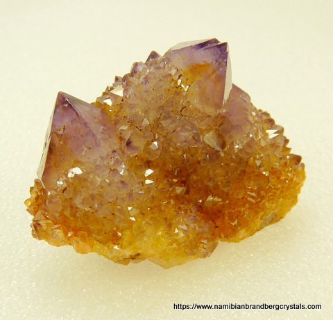 Light amethyst cactus quartz crystal group with iron oxide colouring