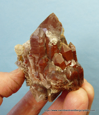 athedral quartz crystal with hematite captured between layers of quartz growth