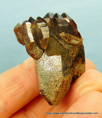Quartz crystal group with dark hematite inclusions
