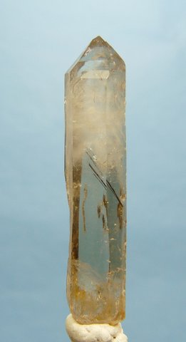 Slender quartz crystal with rutile needles