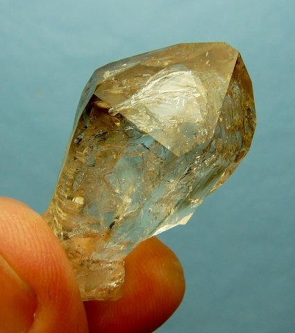 Lovely, gemmy quartz crystal with very light smoky colour, moving bubble and rainbow