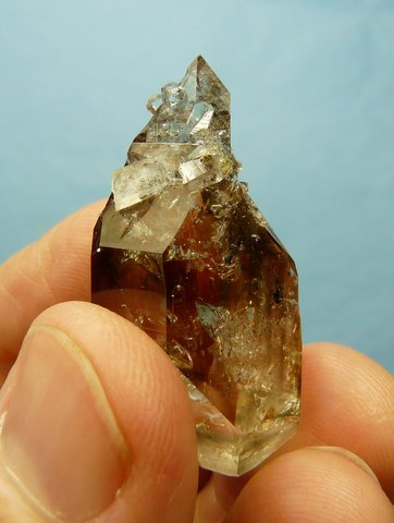 Double terminated quartz crystal with smoky patches and crystal inclusions