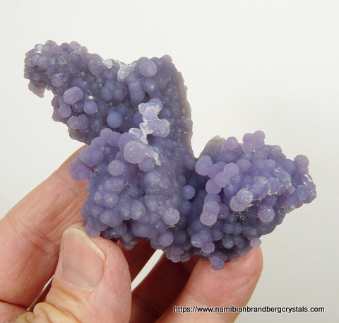 A cluster of purple chalcedony aggregates, multi-sided specimen