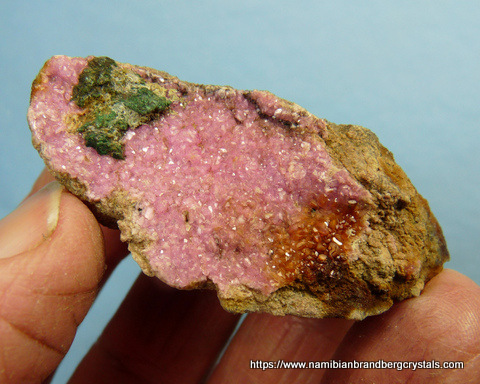 Cobaltoan dolomite crystals with bits of malachite, on rock matrix