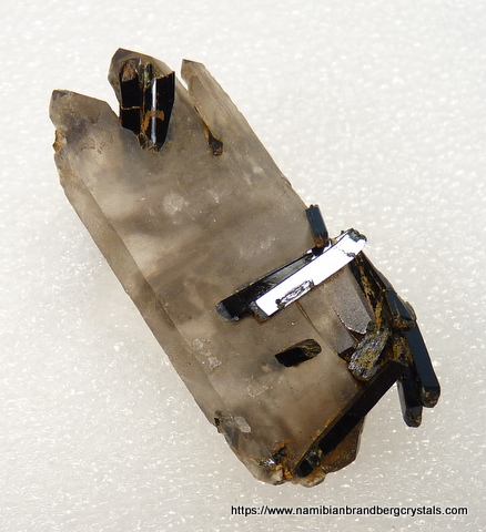 Quartz crystal with aegerine crystals inside and on top Quartz crystal with aegerine crystals inside and on top